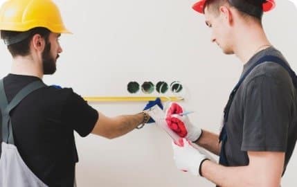 Hands wiring a new smart light switch, connecting line, neutral, and ground wires safely in electrical box